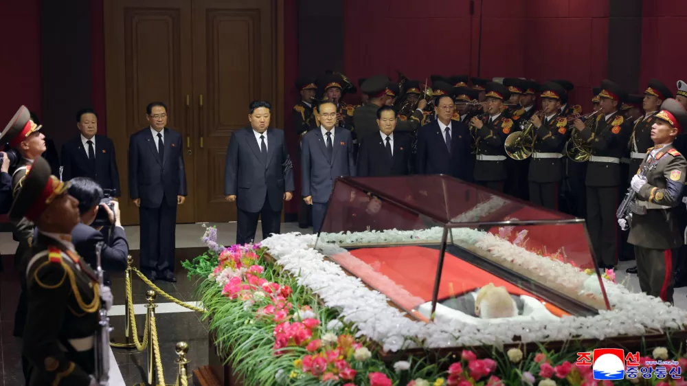 In this photo provided by the North Korean government, its leader Kim Jong Un, back third left, offers his condolences in front of the coffin of Kim Yong Nam at an undisclosed location in North Korea, early Tuesday, Nov. 4, 2025. Independent journalists were not given access to cover the event depicted in this image distributed by the North Korean government. The content of this image is as provided and cannot be independently verified. Korean language watermark on image as provided by source reads: "KCNA" which is the abbreviation for Korean Central News Agency. (Korean Central News Agency/Korea News Service via AP)