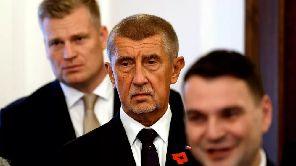 Leader of ANO party Andrej Babis stands between the leader of the Motorists party Petr Macinka and the honorary president of the Motorists party Filip Turek after signing a coalition agreement at the Czech Parliament in Prague, Czech Republic, November 3, 2025. REUTERS/David W Cerny