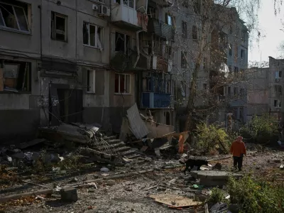 A resident walks near apartment buildings damaged by a Russian military strike, amid Russia's attack on Ukraine, in the frontline town of Kostiantynivka in Donetsk region, Ukraine November 3, 2025. REUTERS/Anatolii Stepanov