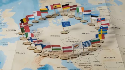 colorful flags of european union member countries arranged in a symbolic circle on a detailed political map of europe / Foto: Alina Vytiuk