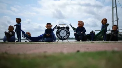 Oxfam activists wearing big head masks depicting world leaders stage a "Sleeping on the Job" protest to criticize the inadequacy of decisions made by the world's largest economies in combating the climate crisis, ahead of the United Nations Climate Change Conference COP30 in Belem, Brazil, November 5, 2025. REUTERS/Adriano Machado   TPX IMAGES OF THE DAY