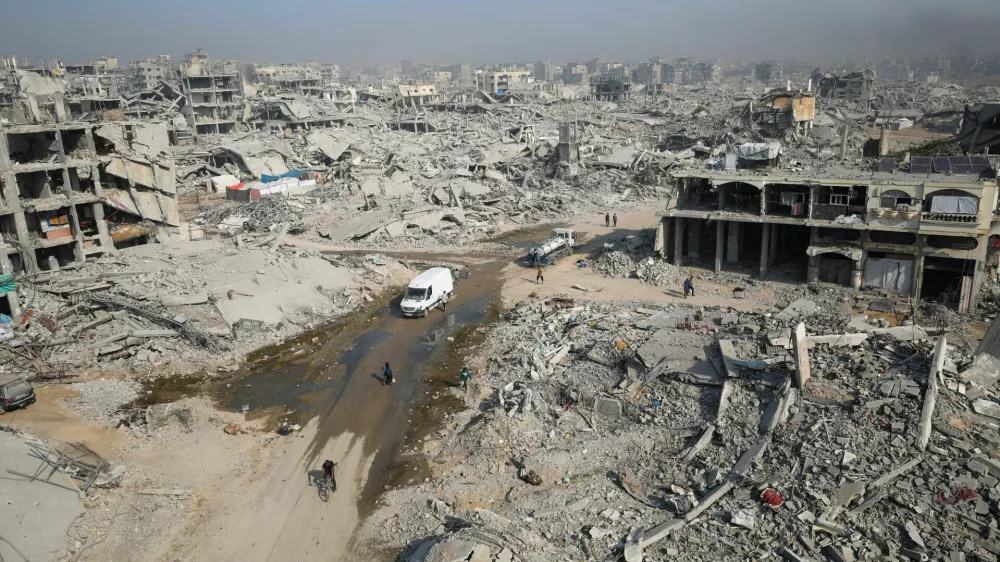 Palestinians walk past the rubble of destroyed buildings, amid a ceasefire between Israel and Hamas, in Gaza City, November 5, 2025. REUTERS/Dawoud Abu Alkas