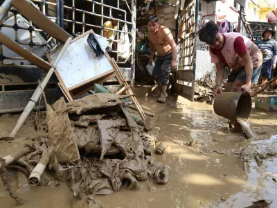 Residents clean up outside their homes after Typhoon Kalmaegi caused devastation in communities at Talisay City, Cebu province, central Philippines, Wednesday, Nov. 5, 2025. (AP Photo/Jacqueline Hernandez)