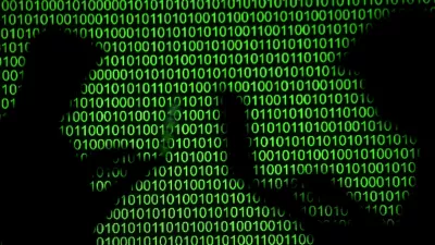 FILE PHOTO: Silhouettes of laptop users are seen next to a screen projection of binary code in this picture illustration created on March 28, 2018. REUTERS/Dado Ruvic/Illustration/File Photo