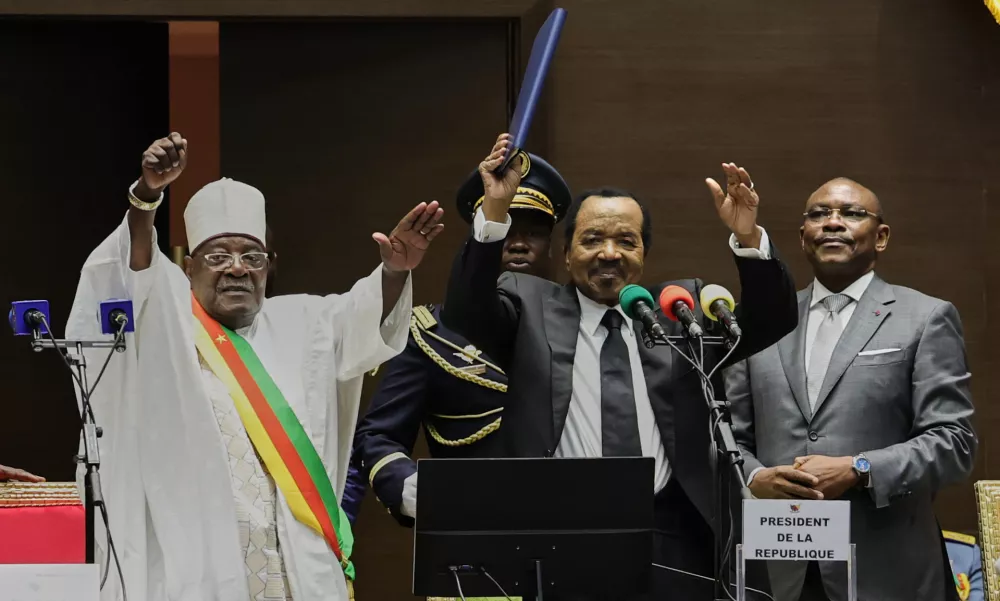 Cameroon's President Paul Biya, second from right, raises his hand after being sworn in for a new term during his inauguration ceremony at the National Assembly in Yaounde, Cameroon, Thursday, Nov. 6, 2025. (AP Photo/Angel Ngwe)