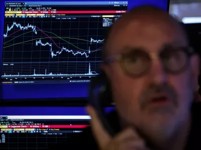 FILE PHOTO: A trader works on the floor at the New York Stock Exchange (NYSE) in New York City, U.S., October 29, 2025. REUTERS/Brendan McDermid/File Photo