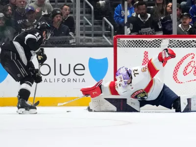 Florida Panthers goaltender Sergei Bobrovsky, right, stops a shot by Los Angeles Kings center Anze Kopitar during the third period of an NHL hockey game Thursday, Nov. 6, 2025, in Los Angeles. (AP Photo/Mark J. Terrill)