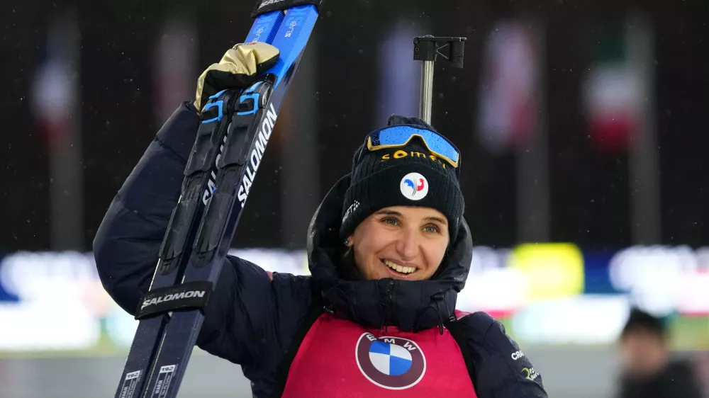 Julia Simon of France celebrates after winning the women's 10 km pursuit race at the Biathlon World Championship in Nove Mesto na Morave, Czech Republic, Sunday, Feb. 11, 2024. (AP Photo/Petr David Josek)