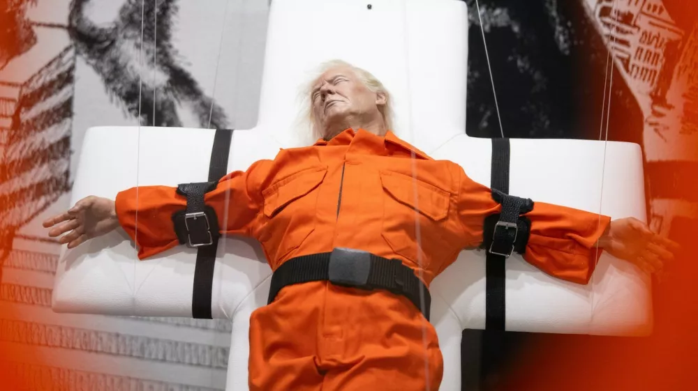 This photograph shows the art piece by British artist Mason Storm called "Saint or Sinner", depicting US President Donald Trump dressed in an orange prison jumpsuit on a cross, displayed at an exhibition space in Basel on November 3, 2025.,Image: 1050059853, License: Rights-managed, Restrictions: RESTRICTED TO EDITORIAL USE - MANDATORY MENTION OF THE ARTIST UPON PUBLICATION - TO ILLUSTRATE THE EVENT AS SPECIFIED IN THE CAPTION, Model Release: no