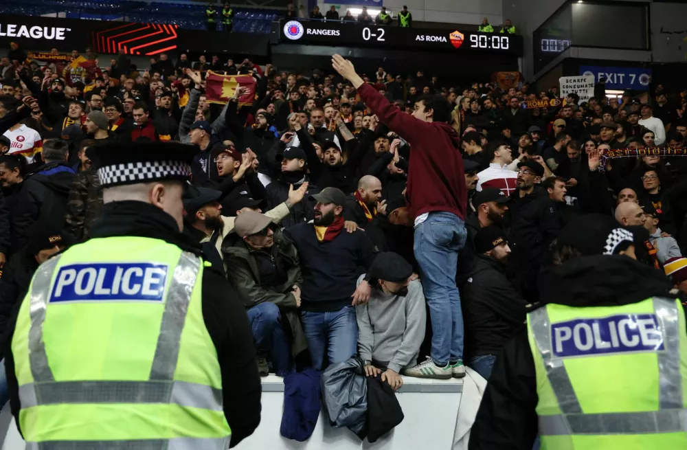 Soccer Football - UEFA Europa League - Rangers v AS Roma - Ibrox, Glasgow, Scotland, Britain - November 6, 2025 AS Roma fans celebrate in the stands after the match as police officers look on REUTERS/Russell Cheyne