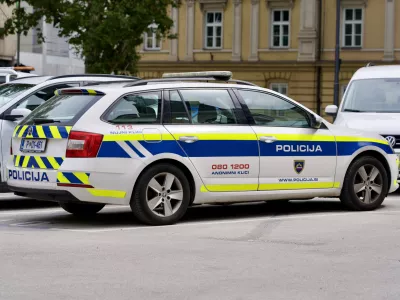 Parked Skoda police car at town square of the old town of Ljubljana on a cloudy summer day. Photo taken August 9th, 2023, Ljubljana, Slovenia.