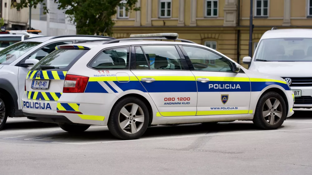 Parked Skoda police car at town square of the old town of Ljubljana on a cloudy summer day. Photo taken August 9th, 2023, Ljubljana, Slovenia.