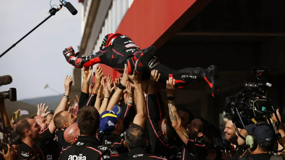 MotoGP - Portuguese Grand Prix - Algarve International Circuit, Portimao, Portugal - November 9, 2025 Aprilia Racing's Marco Bezzecchi celebrates with team after winning the MotoGP race REUTERS/Marcelo Del Pozo