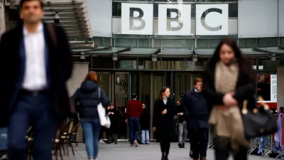﻿FILE PHOTO: Pedestrians walk past a BBC logo at Broadcasting House in London, Britain, January 29, 2020. REUTERS/Henry Nicholls/File Photo