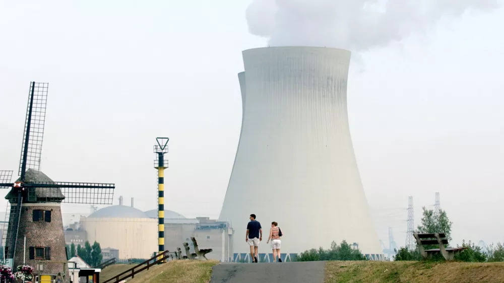 A couple walks toward the cooling towers of a nuclear power plant in Doel, Belgium, Thursday Aug, 7, 2003. With a sweltering heat wave continuing to blanket much of Europe, many nuclear power plants have had to consider reducing their production due to high temperatures on the cooling towers. (AP Photo/Virginia Mayo)