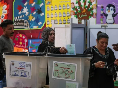 A woman votes at a school used as a polling station, during the first round of Egypt's parliamentary elections, in Giza, Egypt, November 10, 2025. REUTERS/Mohamed Abd El Ghany