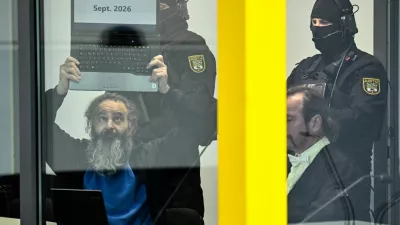 Suspect Taleb al-Abdulmohsen, a 51-year-old doctor from Saudi Arabia, who faces charges of murder, attempted murder and dangerous interference with road traffic, shows a laptop with the text "Sept. 2026", at the opening of his trial for the Magdeburg Christmas market attack, at a regional court in Magdeburg, Germany, November 10, 2025. REUTERS/Annegret Hilse