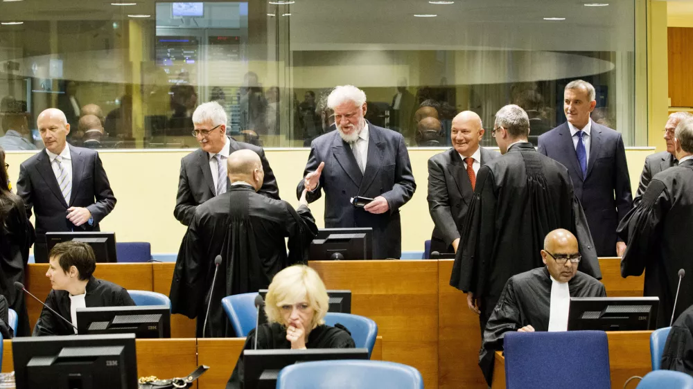 Back row from left: Bosnian Croats Jadranko Prlic, Bruno Stojic, Slobodan Praljak, Milivoj Petkovic, Valentin Coric and Berislav Pusic prior to their judgment at the Yugoslav war crimes tribunal (ICTY) in The Hague, Netherlands, Wednesday May 29, 2013. The ICTY delivers verdicts in the long-running trial of six senior Bosnian Croats on charges of crimes against Muslims and Serbs as they tried to carve out a Croat state in Bosnia during the country's 1992-95 war. Prosecutors have asked for sentences of up to 40 years for the suspects. (AP Photo/Jiri Buller, Pool)