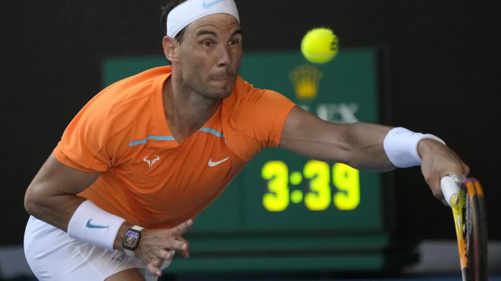 Rafael Nadal of Spain plays a forehand return to Jack Draper of Britain during their first round match at the Australian Open tennis championship in Melbourne, Australia, Monday, Jan. 16, 2023. (AP Photo/Aaron Favila)