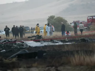 Members of emergency services work at the site of the Turkish C-130 military cargo plane crash near the Azerbaijani border, in Sighnaghi municipality, Georgia, November 12, 2025. REUTERS/Irakli Gedenidze