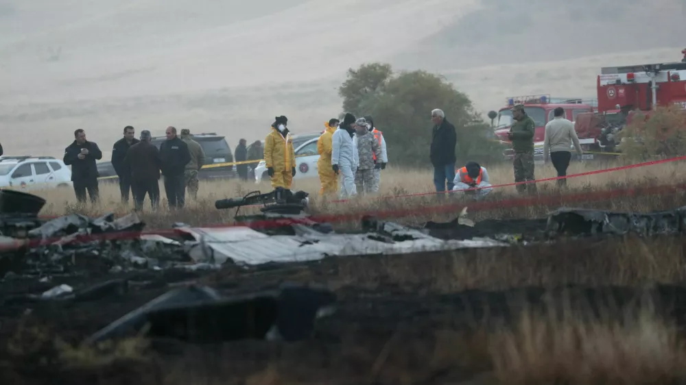 Members of emergency services work at the site of the Turkish C-130 military cargo plane crash near the Azerbaijani border, in Sighnaghi municipality, Georgia, November 12, 2025. REUTERS/Irakli Gedenidze