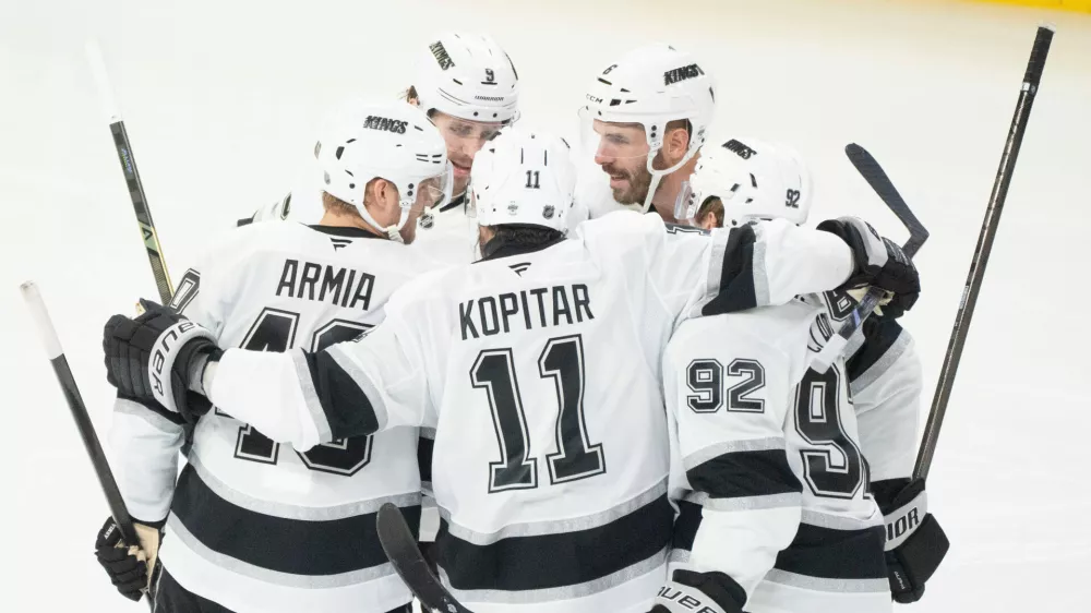Los Angeles Kings' Joel Edmundson (6) celebrates his goal over Montreal Canadiens with teammates Brandt Clarke (92), Anze Kopitar (11), Joel Armia (40) and Adrian Kempe (9) during second period NHL hockey action in Montreal on Tuesday, Nov. 11, 2025. (Christinne Muschi/The Canadian Press via AP)