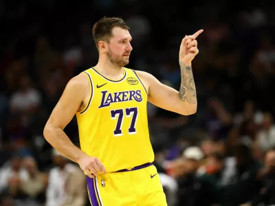 Oct 14, 2025; Phoenix, Arizona, USA; Los Angeles Lakers guard Luka Doncic (77) reacts against the Phoenix Suns during an NBA preseason game at Mortgage Matchup Center. Mandatory Credit: Mark J. Rebilas-Imagn Images
