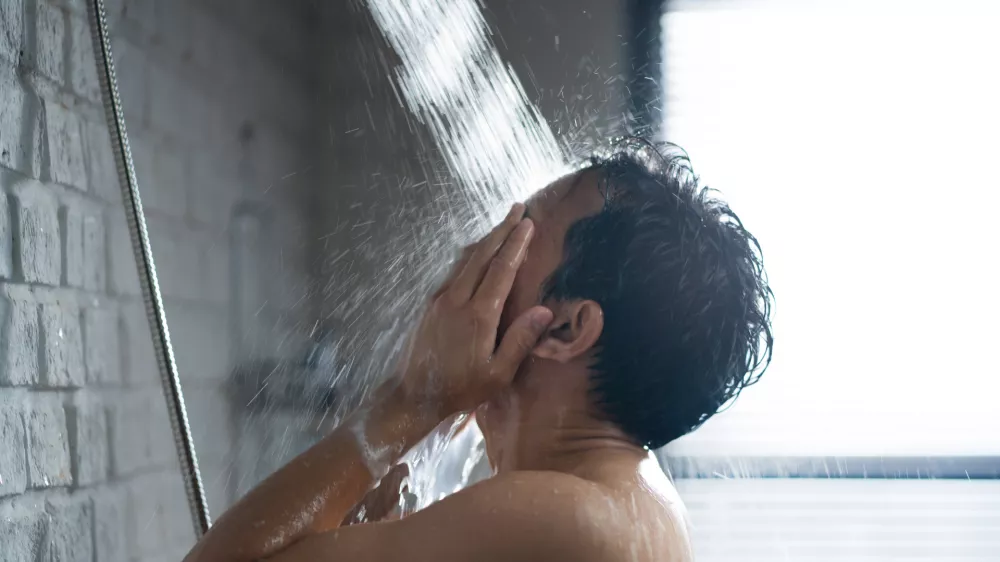 Handsome asian guy Taking a shower in the bathroom / Foto: Torwai