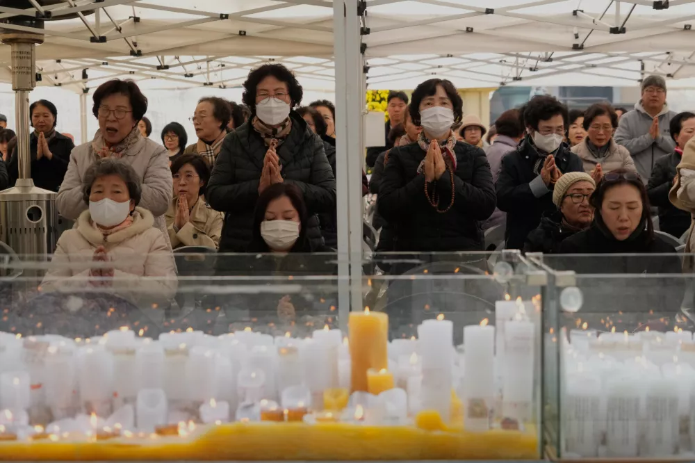 Buddhist believers pray during a special service to wish for their children's success of the college entrance exam, the College Scholastic Ability Test, at the Jogye Temple, in Seoul, South Korea, Thursday, Nov. 13, 2025. (AP Photo/Ahn Young-joon)