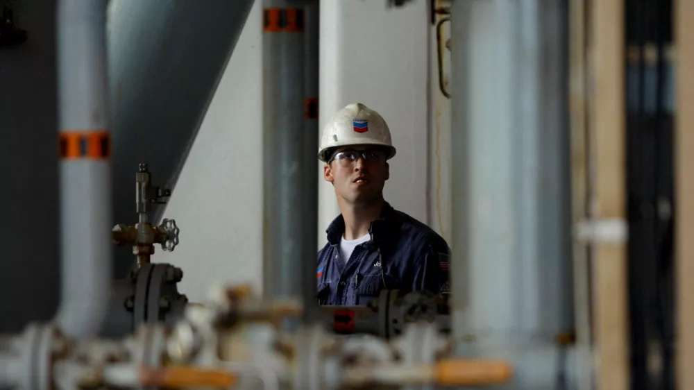 FILE PHOTO: A Chevron employee looks at oil pipes aboard Chevron's Petronius oil platform, located 100 miles (161 km) off the coast of New Orleans, in the Gulf of Mexico June 3, 2008. REUTERS/Jessica Rinaldi/File Photo