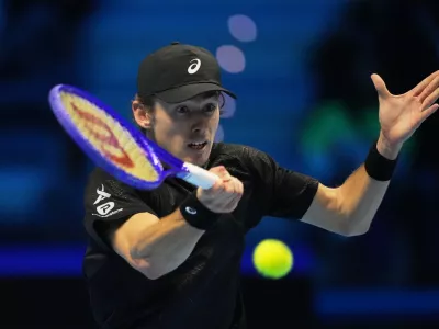 Australia's Alex de Minaur returns the ball to United States' Taylor Fritz during their tennis match of the ATP World Tour Finals, in Turin, Italy, Thursday, Nov. 13, 2025. (AP Photo/Antonio Calanni)