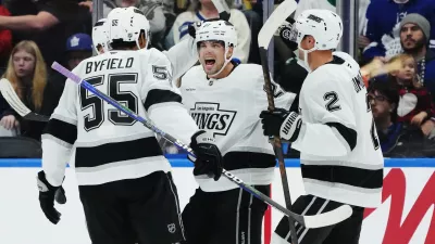 Los Angeles Kings' Kevin Fiala (second right) celebrates his goal against the Toronto Maple Leafs with Quinton Byfield (55) and Brian Dumoulin (2) during second period NHL hockey in Toronto on Thursday, Nov. 13, 2025. (Nathan Denette/The Canadian Press via AP)
