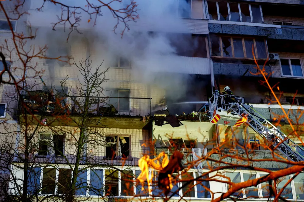Firefighters work at the site of an apartment building hit during an overnight Russian drone and missile strike, amid Russia's attack on Ukraine, in Kyiv, Ukraine, November 14, 2025. REUTERS/Valentyn Ogirenko
