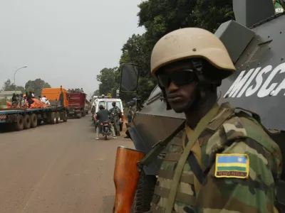 ﻿African peace keeping soldiers escort a humanitarian convoy in Bangui, February 15, 2014. France said on Friday it plans to send another 400 troops to help combat a crisis in the Central African Republic as U.N. chief Ban Ki-moon pleaded for more swift, robust international help to stop sectarian violence that could turn into a genocide. REUTERS/Luc Gnago (CENTRAL AFRICAN REPUBLIC - Tags: POLITICS CIVIL UNREST MILITARY) - RTX18VGQ