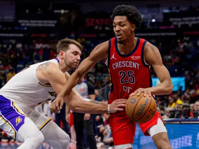 Nov 14, 2025; New Orleans, Louisiana, USA; Los Angeles Lakers forward/guard Luka Dončić (77) reaches in and misses the ball against New Orleans Pelicans forward Trey Murphy III (25) during the second half at Smoothie King Center. Mandatory Credit: Stephen Lew-Imagn Images