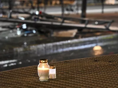 Candles for victims sit at the scene of the accident after a bus crashed into a bus stop in Östermalm in Stockholm, Sweden, Friday. Nov. 14, 2025. (Henrik Montgomery/TT News Agency via AP)
