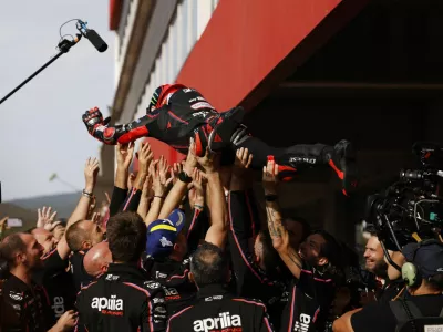 MotoGP - Portuguese Grand Prix - Algarve International Circuit, Portimao, Portugal - November 9, 2025 Aprilia Racing's Marco Bezzecchi celebrates with team after winning the MotoGP race REUTERS/Marcelo Del Pozo