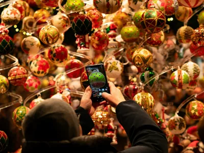 A person takes a picture of Christmas decorations at the Wiener Christkindlmarkt in front of Vienna's city hall, one of the city's most popular Christmas markets in Vienna, Austria, November 15, 2025. REUTERS/Elisabeth Mandl