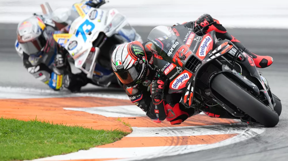 Italian rider Marco Bezzecchi of the Aprilia Racing, right, and Spain's rider Alex Marquez of the BK8 Gresini Racing MotoGP, left, compete during the Valencia Motorcycle MotoGP Grand Prix at the Ricardo Tormo circuit in Cheste, near Valencia, Spain, Sunday, Nov. 16, 2025. (AP Photo/Alberto Saiz)