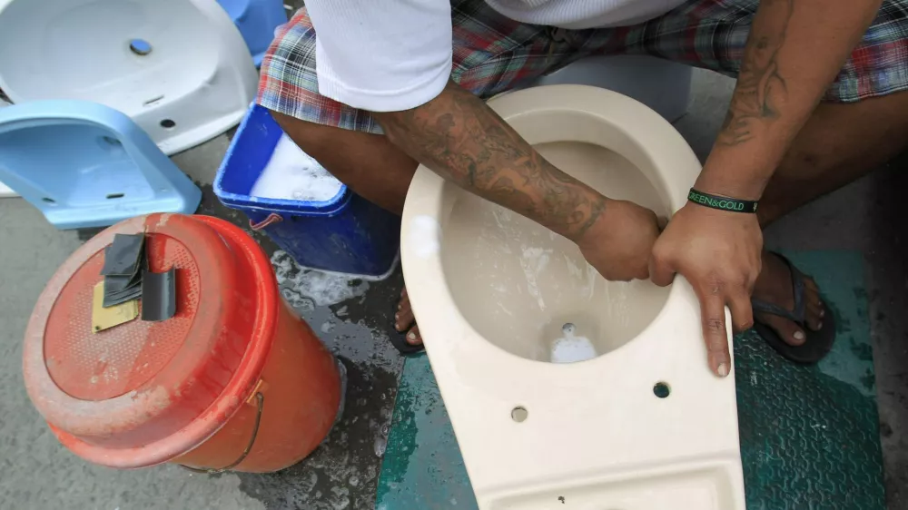 A worker cleans a recycled toilet bowl before putting for sale at 1,500 pesos ($34) each along a major street in Manila November 19, 2014. The United Nations General Assembly has declared November 19 as World Toilet Day to raise awareness about the need for all human beings to have access to sanitation. REUTERS/Romeo Ranoco (PHILIPPINES - Tags: SOCIETY)