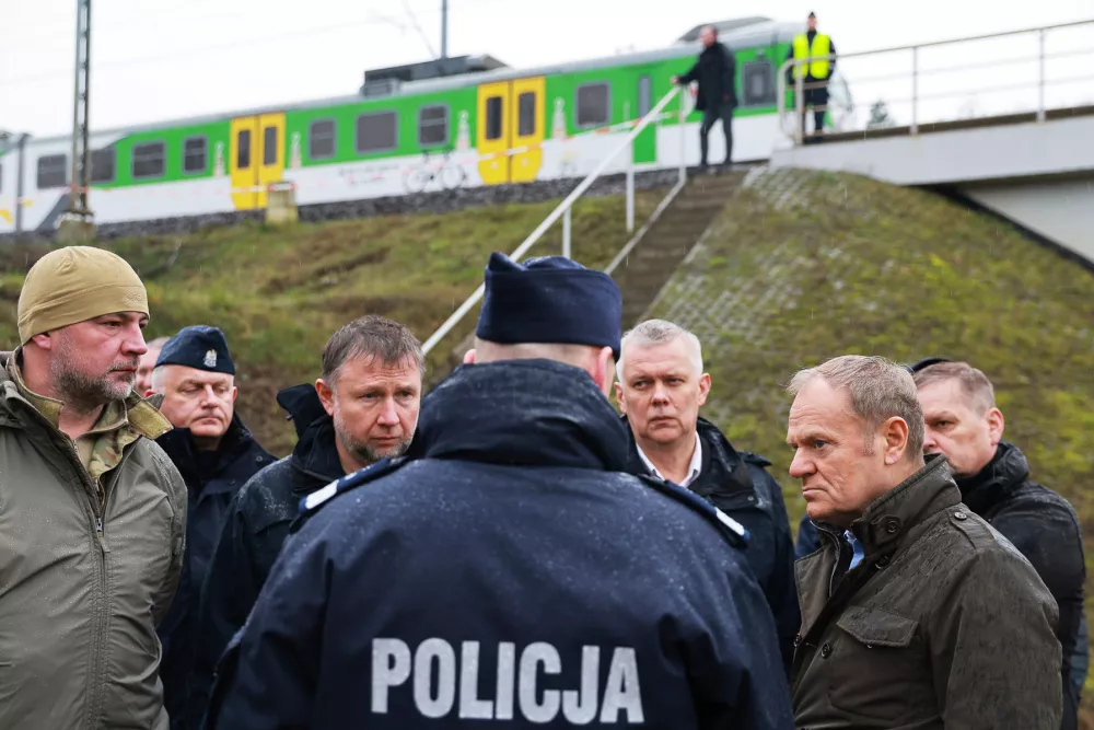 Prime Minister Donald Tusk, second right, visits site of the rail line Mika, that was damaged by sabotage, near Deblin, Poland, Monday, Nov. 17, 2025. (AP Photo/KPRM)