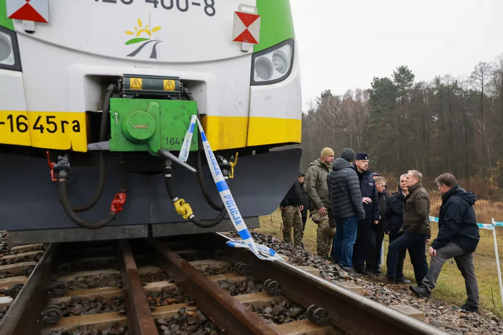 Prime Minister Donald Tusk, second right, visits site of the rail line Mika, that was damaged by sabotage, near Deblin, Poland, Monday, Nov. 17, 2025. (AP Photo/KPRM)