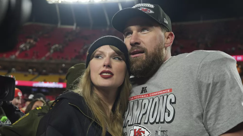 FILE - Kansas City Chiefs tight end Travis Kelce, right, is congratulated by Taylor Swift as they celebrate the Chiefs victory over the Buffalo Bills in the AFC Championship NFL football game, Jan. 26, 2025, in Kansas City, Mo. (AP Photo/Charlie Riedel, File)