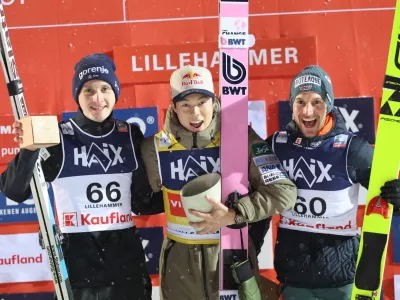 Winner Japan's Ryoyu Kobayashi, center, on the podium with second placed Domen Prevc, left, and third placed Germany's Felix Hoffmann after the men's world cup competition in the large Lysgardsbakken at the ski jumping world cup in Lillehammer, Norway, Sunday Nov. 23, 2025. (Geir Olsen/NTB via AP)