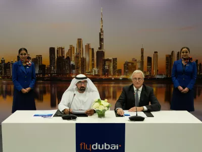 Sheikh Ahmed bin Saeed Al Maktoum, the chairman and chief executive of Emirates and chairman of FlyDubai speaks as Airbus' CEO of commercial aircraft Christian Scherer, right, looks on at a press conference to announce an order for 150 Airbus A321neo aircraft at the Dubai Air Show, United Arab Emirates, Tuesday, Nov. 18, 2025. (AP Photo/Altaf Qadri)