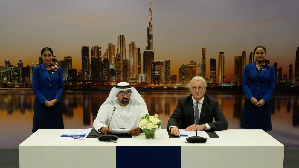 Sheikh Ahmed bin Saeed Al Maktoum, the chairman and chief executive of Emirates and chairman of FlyDubai speaks as Airbus' CEO of commercial aircraft Christian Scherer, right, looks on at a press conference to announce an order for 150 Airbus A321neo aircraft at the Dubai Air Show, United Arab Emirates, Tuesday, Nov. 18, 2025. (AP Photo/Altaf Qadri)