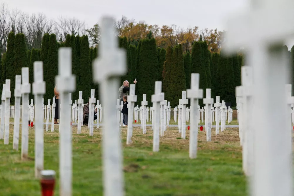 A man takes a picture at the Memorial cemetery to the victims of the Homeland War in Vukovar, Croatia, November 15, 2025. REUTERS/Antonio Bronic