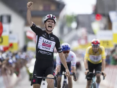 Joao Almeida of Portugal wins the seventh stage, a 207 km race from Neuhausen am Rheinfall to Emmetten, at the 88th Tour de Suisse UCI World Tour cycling race, Saturday, June 21, 2025. (Gian Ehrenzeller/Keystone via AP)
