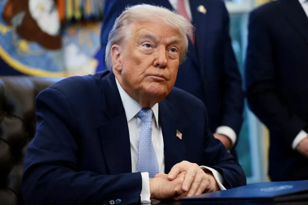 FILE PHOTO: U.S. President Donald Trump looks on as he meets with the White House Task Force on the FIFA World Cup 2026 in the Oval Office at the White House in Washington, D.C., U.S., November 17, 2025. REUTERS/Evelyn Hockstein/File Photo