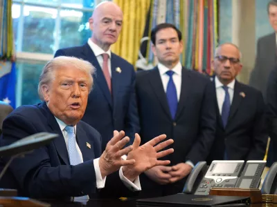 President Donald Trump answers questions from reporters during a meeting with the White House task force on the 2026 FIFA World Cup in the Oval Office of the White House, Monday, Nov. 17, 2025, in Washington, as FIFA President Gianni Infantino, Secretary of State Marco Rubio and FIFA senior adviser Carlos Cordeiro listen. (AP Photo/Evan Vucci)